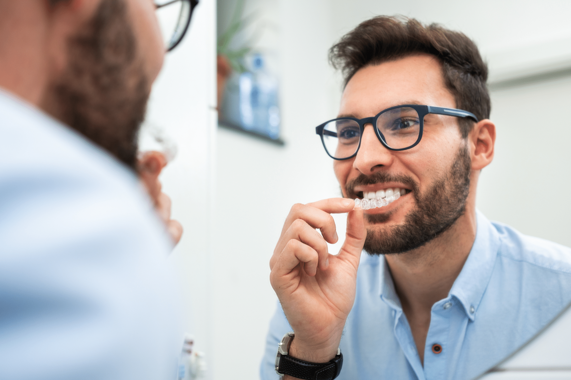 Adult patient trying clear aligners during an orthodontic visit in Glen Allen VA